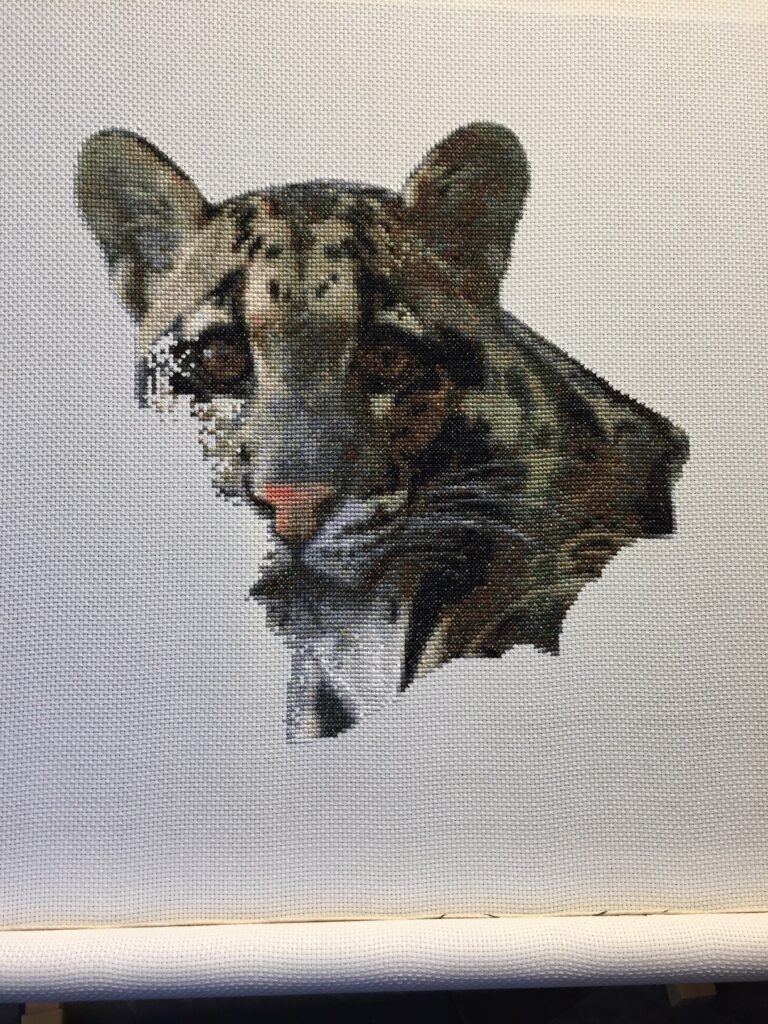 Detailed Clouded Leopard cross stitch kit near completion.