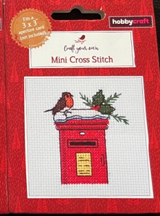 How to make a mini cross stitch kit front of the box - robin on a snowy pillar post box with holly leaves.