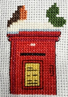 Back stitch detailing on the mail box.